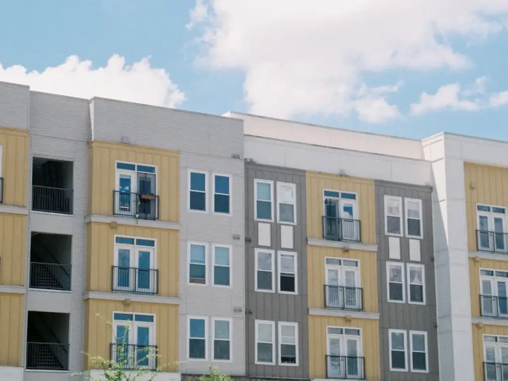 Multi-family apartment building exterior under a blue sky