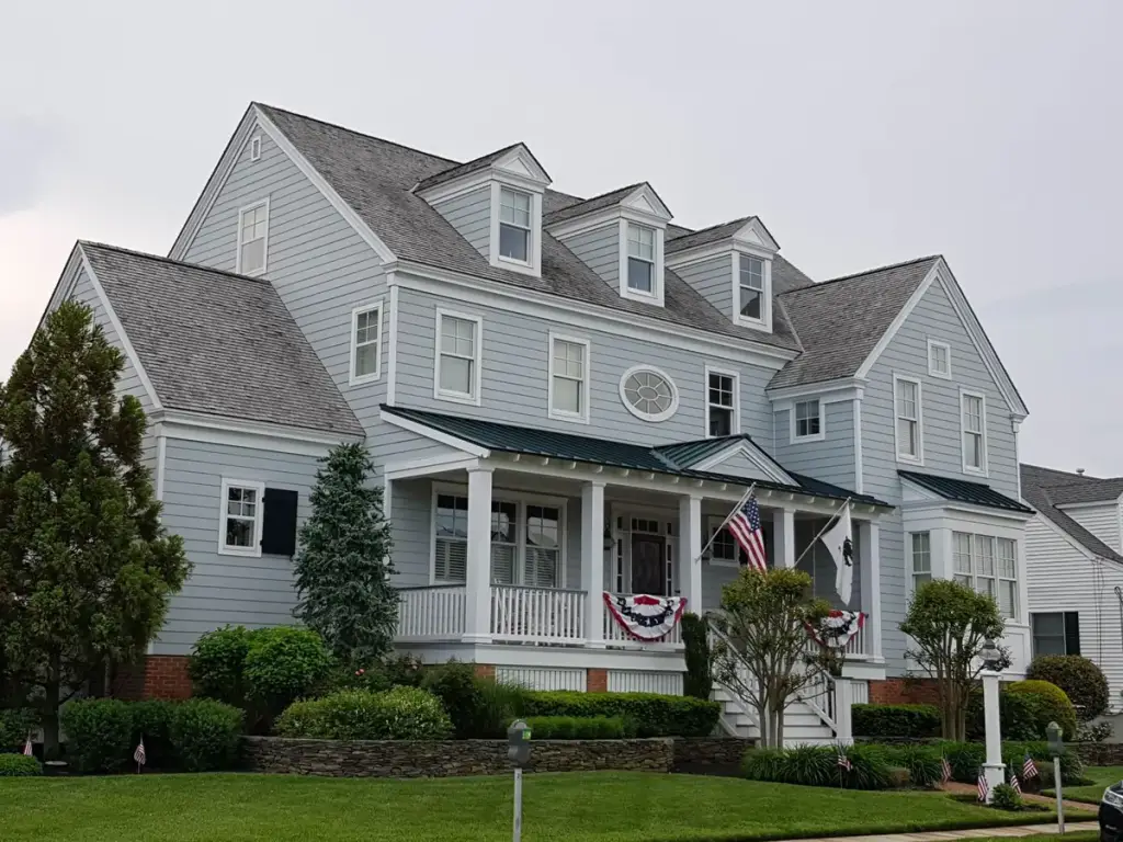 Two storey house with blue-grey lap siding and a front porch