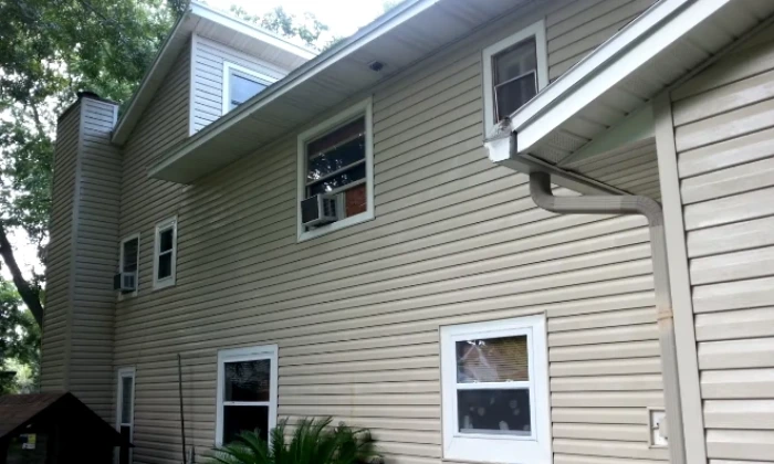 Two storey home with tan lap siding after exterior cleaning