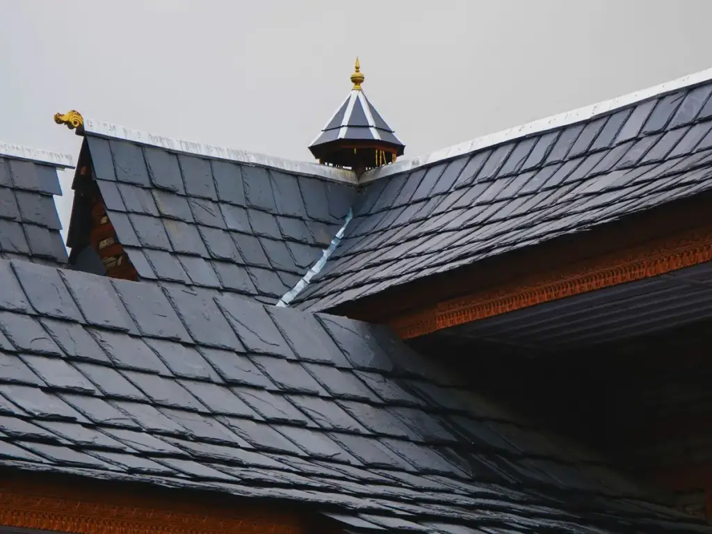 Steep dark roof slopes meeting at a ridge