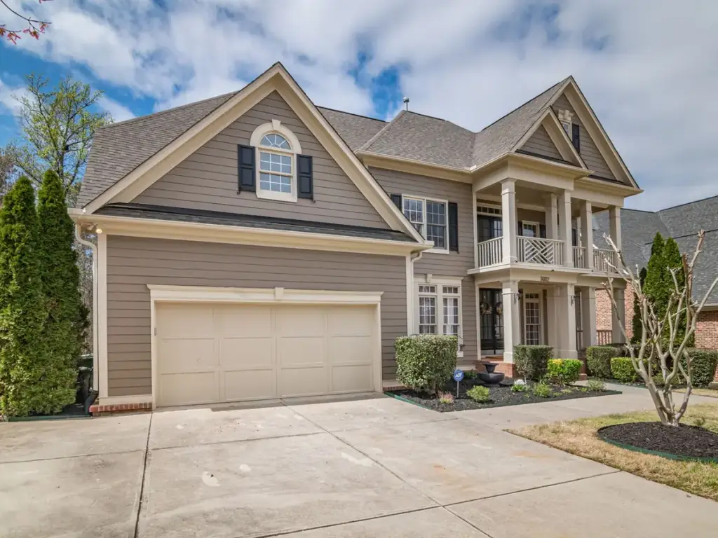 Two storey suburban house with lap siding and a double garage